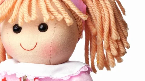 Closeup face rag doll smiling on a white background	 Stock Footage 124286197