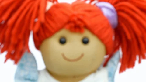 Closeup face rag doll smiling on a white background focus transition animatio Stock Footage 129111964