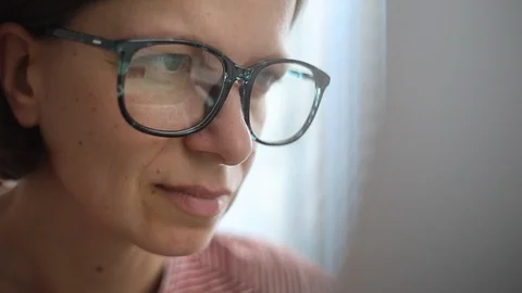 Closeup of the face of a woman looking at a computer screen.  Stock Footage 119157306