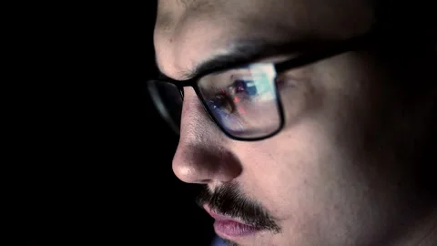 Closeup face of young man with glasses which reflects computer screen, front Stock Footage 196885217