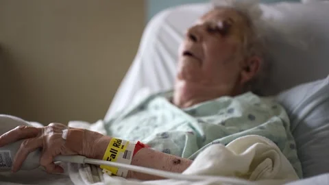 Closeup of Fall Risk wristband on elderly womans arm holding emergency call 스톡 동영상 285148933