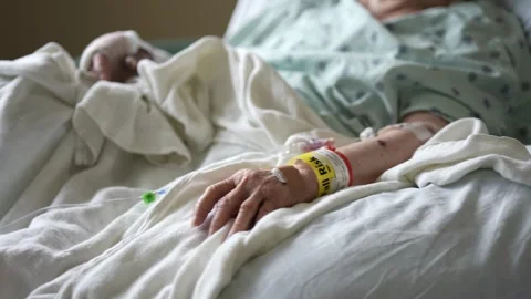 Closeup of Fall Risk wristband on elderly womans hand while lying in hospital 스톡 동영상 286240987
