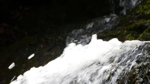 Closeup on fast flowing mountain stream over rocks Stock Footage 74312398