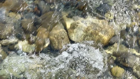 Closeup of fast flowing stream. Bubbles and foam on water surface, Stock Footage 116502190