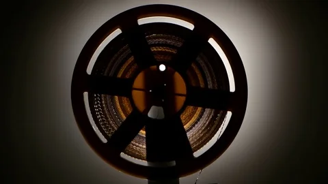 Closeup. Fast rewind tape on the old retro cinema projector Stock Footage 73663046
