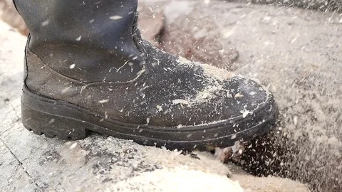 Closeup of the feet of a man operating a chainsaw Stock Footage 70845129