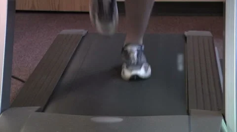 Closeup of feet running on treadmill. Stock Footage 49862942