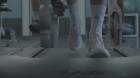 Closeup of Feet Running on a Treadmill Stock Footage 154003334
