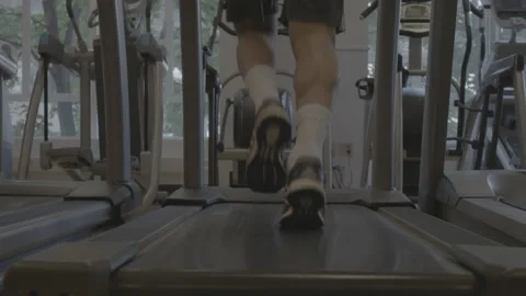 Closeup of Feet Running on a Treadmill Stock Footage 154004142
