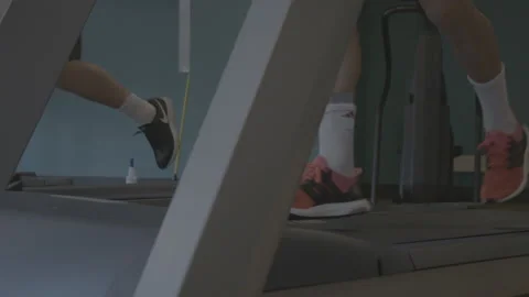Closeup of Feet Running on a Treadmill Stock Footage 154004331