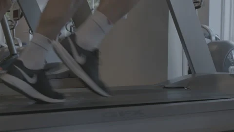Closeup of Feet Running on a Treadmill Stock Footage 154004468