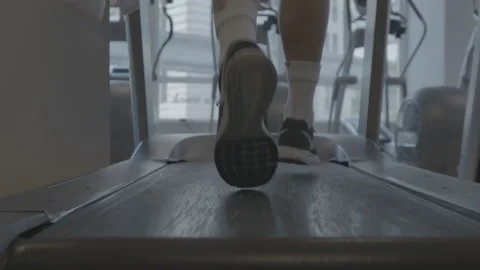 Closeup of Feet Running on a Treadmill Stock Footage 154004485