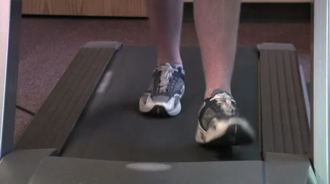 Closeup of feet walking on treadmill. Stock Footage 49863024