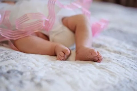Closeup feets of the child on the bed Stock Photos