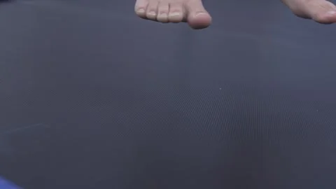 Closeup of feets jumping on a trampoline. Stock Footage 313827836