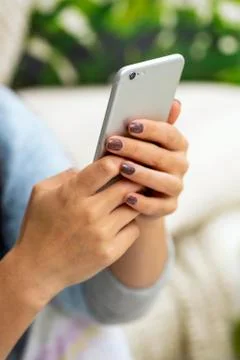 Closeup of female hand using a smart phone Stock Photos