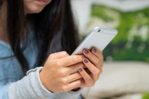 Closeup of female hand using a smart phone Stock Photos