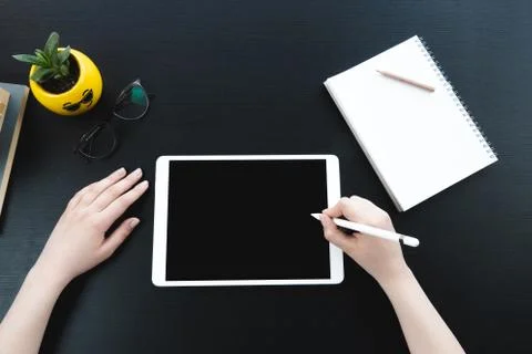 Closeup of female hand using tablet create and design job Stock Photos
