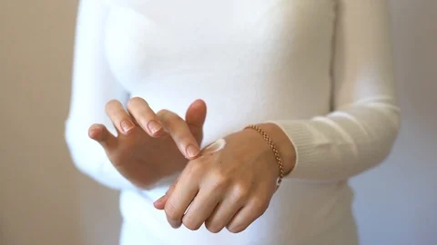 Closeup of female hands applying hand cream Stock Footage 124637653