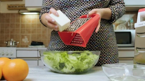Closeup of female hands grating chees for salad in the kitchen. Healthy Food  Stock Footage 121640193