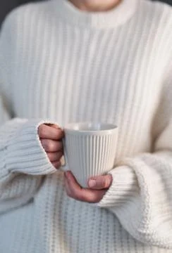 Closeup of female hands with mug of hot drink Stock-Fotos
