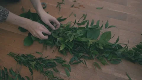 Closeup of female hands preparing decorations for a wedding 動画素材 130859048