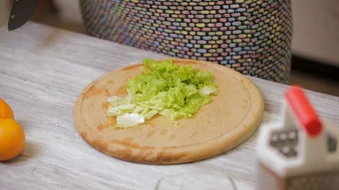 Closeup of female hands preparing vegetable salad in the kitchen. Healthy Foo Stock Footage 121639839
