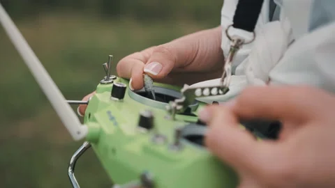 Closeup female hands remote control sticks of control of FPV racing drone Stock Footage 131199292