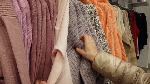 Closeup of female hands sorting through a hanger with clothes. Stock-Footage 125555224