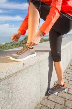 Closeup of female hands tying running shoes laces Stock Photos