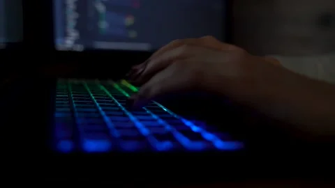 Closeup female hands is typing on laptop keyboard with colored backlight. Sof Stock Footage 149298965