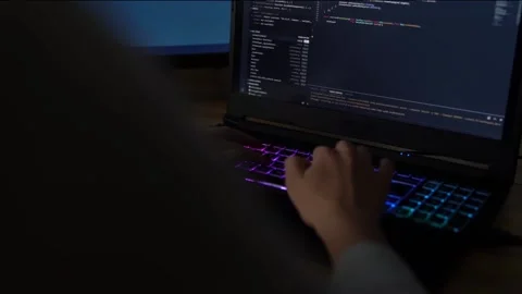 Closeup female hands is typing on laptop keyboard with colored backlight. Sof Stock Footage 149298997