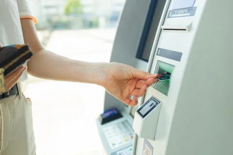 Closeup of female hands using using credit while typing on ATM, bank machine Stock Photos