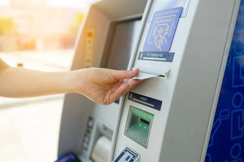 Closeup of female hands using using credit while typing on ATM, bank machine Stock Photos
