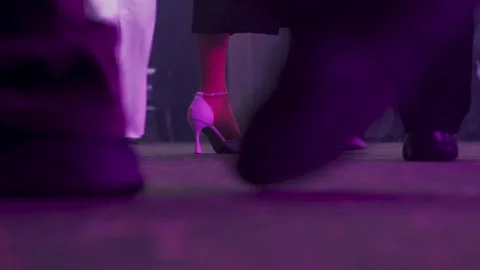 Closeup female heels on dancefloor under purple lights, bridesmaids and guests Stock Footage 323799277