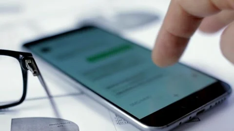 Closeup female relaxes in home using smartphone scrolling on text message or 스톡 동영상 336248867