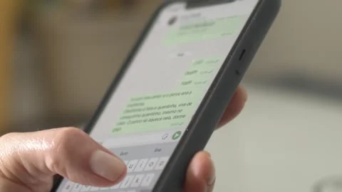 Closeup, female respoding to text message on cell phone using thumb Stock Footage 292967063