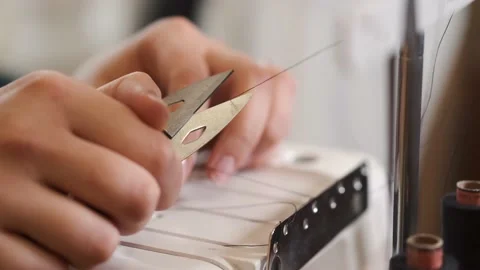 Closeup of female tailor cuting thread in sewing machine Stock Footage 150057376