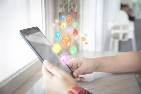 Closeup of female using smart phone with icon digital box social network in.. Stock Photos