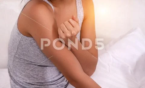 Closeup female's arm. Arm pain and injury. warm light tone,blurry light aroun Stock Photos