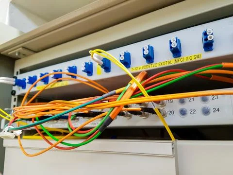 Closeup of fiber optic cable plugged into switch Stock Photos