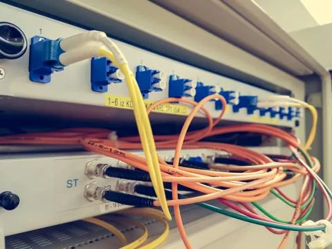 Closeup of fiber optic cable plugged into switch Stock Photos
