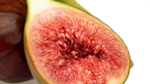 Closeup of fig fruit slice rotating on white background. Stock-Footage 160150461