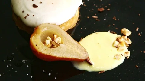 Closeup fine dining dessert spinning around on black plate Stock Footage 120754326
