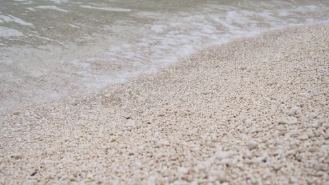 Closeup of fine stone pebbles on the beach with water foaming Stock Footage 112118865