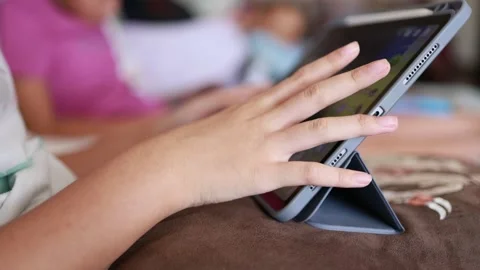 Closeup finger gesturing playing game on digital tablet Stock Footage 167784946