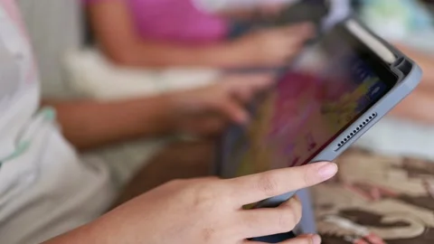 Closeup finger gesturing playing game on digital tablet Stock Footage 167785063