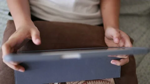 Closeup finger gesturing playing game on digital tablet Stock Footage 167785510