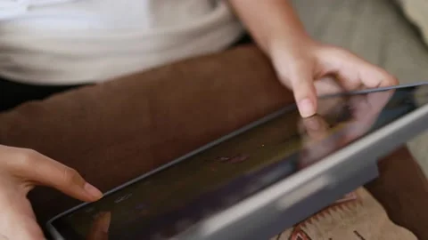 Closeup finger gesturing playing game on digital tablet Stock Footage 167785517