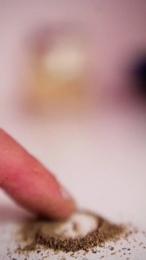Closeup finger pressing coffee grounds on surface, tactile imprint and aroma Stock Footage 321611876